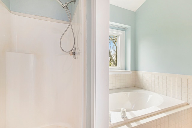 bathroom with a shower stall and a bath