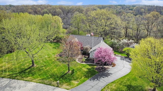 drone / aerial view featuring a forest view