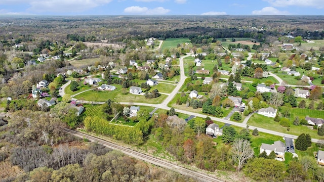 birds eye view of property featuring a residential view and a wooded view