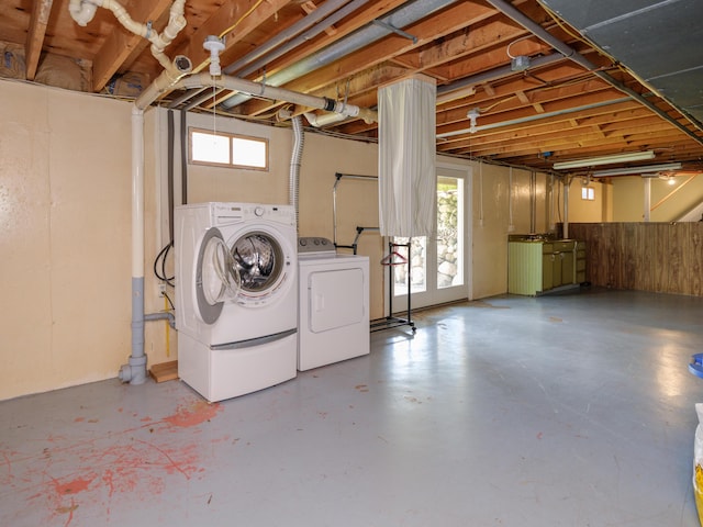 basement with a healthy amount of sunlight and separate washer and dryer