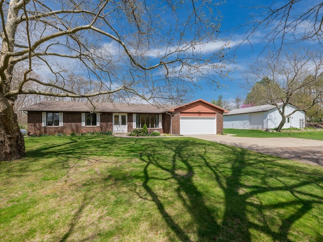 single story home with brick siding, an attached garage, a front yard, and concrete driveway