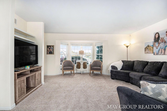 living room with carpet floors, baseboards, and visible vents
