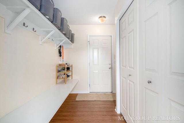 interior space featuring baseboards and wood finished floors