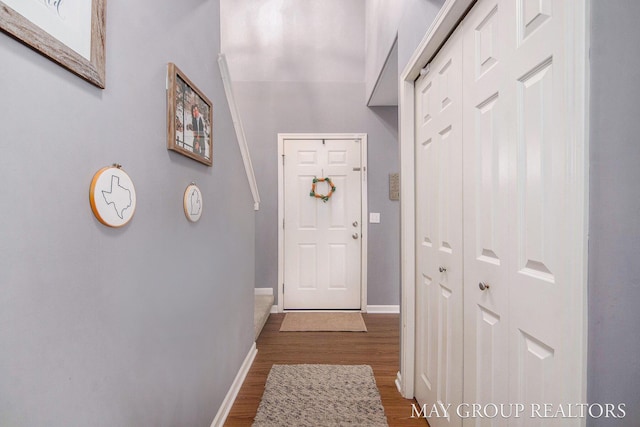 entryway featuring baseboards and wood finished floors