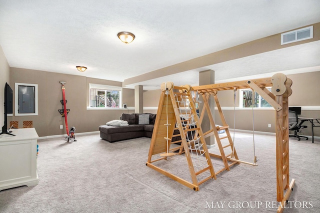 interior space featuring baseboards, electric panel, and visible vents