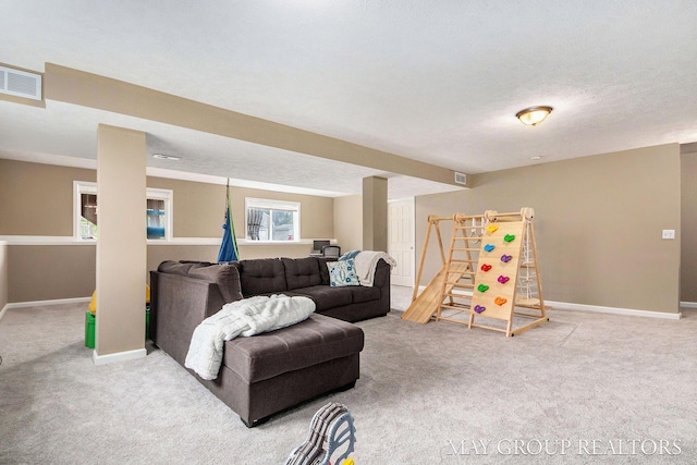 living room featuring visible vents, carpet, and baseboards