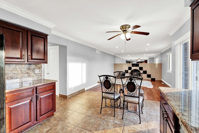 dining room with crown molding, ceiling fan, visible vents, and a wealth of natural light