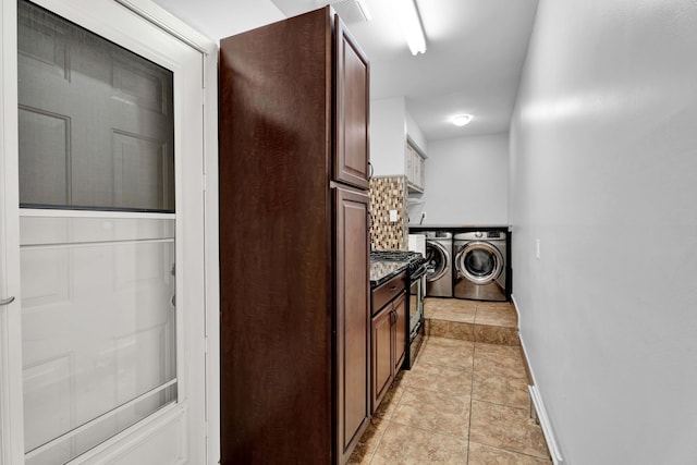 clothes washing area featuring baseboards, washer and dryer, and visible vents