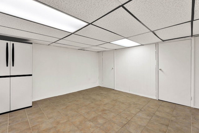 finished basement with a paneled ceiling