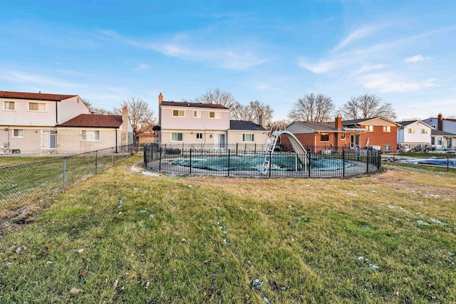 view of yard featuring fence, a fenced in pool, a residential view, and a patio area