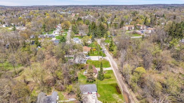 birds eye view of property with a wooded view