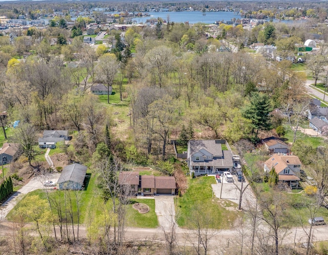 drone / aerial view with a water view and a residential view