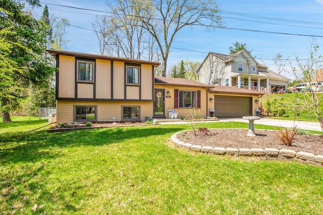 tri-level home with board and batten siding, driveway, and a front yard
