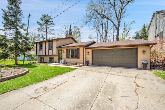 split level home featuring a garage, concrete driveway, and a front lawn