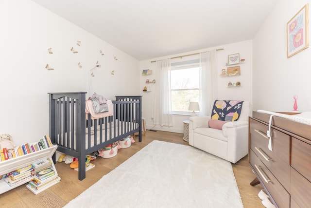 3941 Steamboat Ct, Ann Arbor, MI 48108 - bedroom featuring a nursery area and light wood finished floors