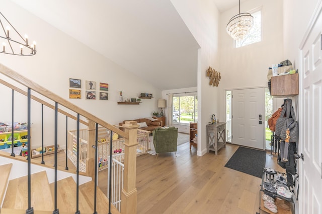 3941 Steamboat Ct, Ann Arbor, MI 48108 - entrance foyer with high vaulted ceiling, a notable chandelier, and light wood-type flooring