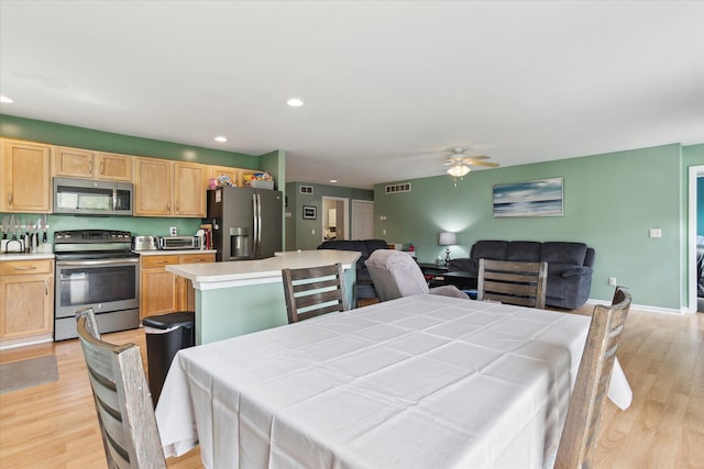 dining area featuring light wood-style floors, a ceiling fan, recessed lighting, a toaster, and visible vents
