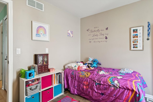 bedroom with visible vents and wood finished floors