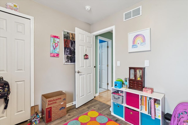 playroom featuring visible vents and wood finished floors