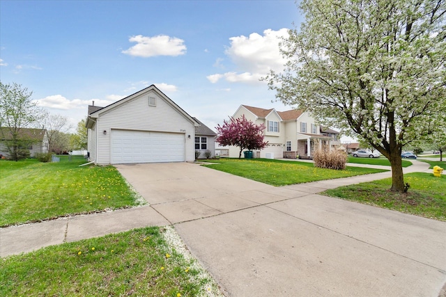 traditional-style home with an attached garage, driveway, and a front yard