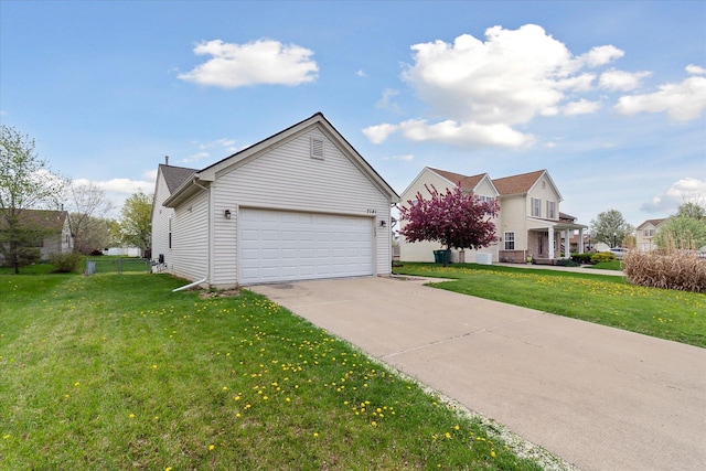 view of front of home featuring a garage, a front lawn, and driveway