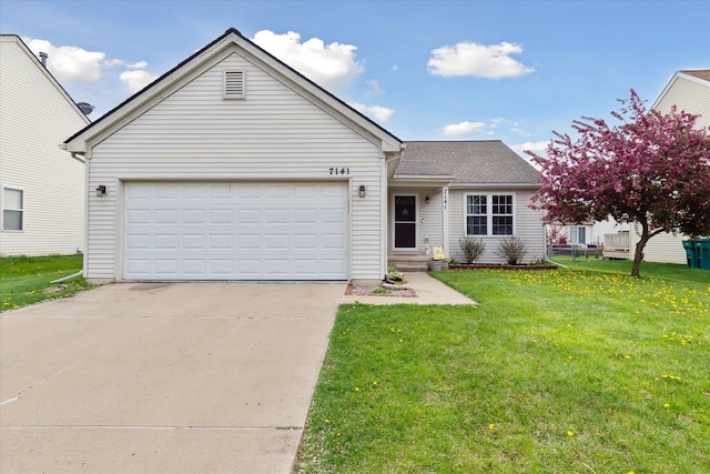 view of front facade with an attached garage, driveway, and a front yard