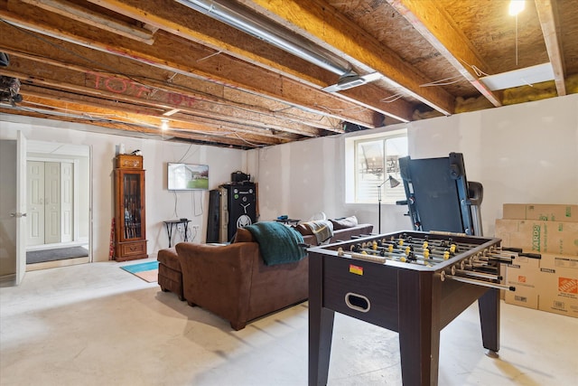 game room featuring unfinished concrete flooring