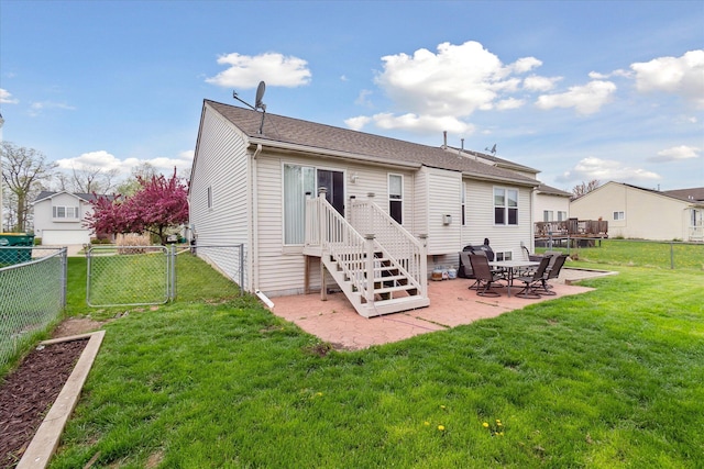 rear view of house featuring a fenced backyard, a gate, a yard, and a patio area
