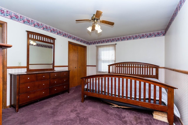 carpeted bedroom featuring a closet and wainscoting