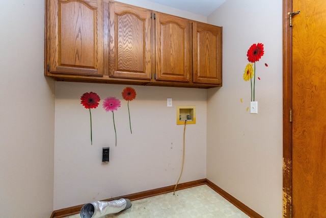 laundry room with cabinet space, washer hookup, baseboards, and light floors