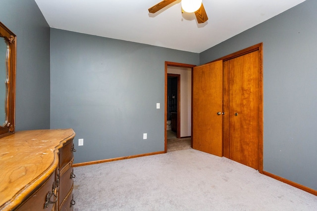 carpeted bedroom with a ceiling fan, baseboards, and a closet