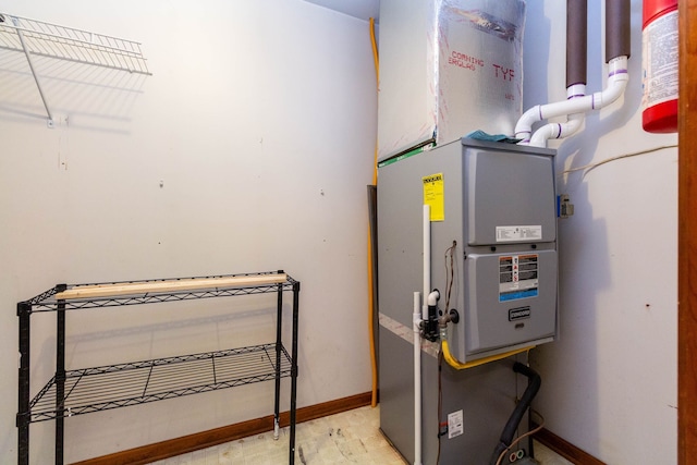 utility room featuring heating unit