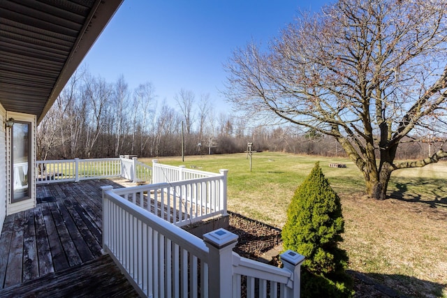 wooden terrace featuring a yard