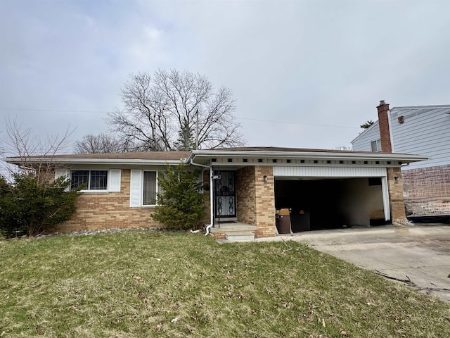 ranch-style home with brick siding, a garage, a front lawn, and concrete driveway