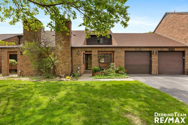 view of front facade featuring brick siding, a garage, driveway, and a front yard