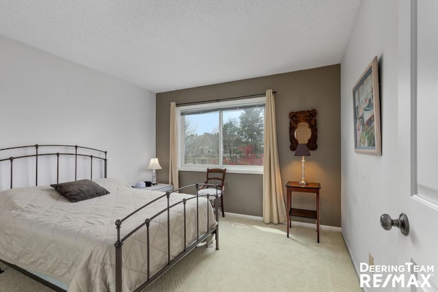 bedroom with carpet floors, a textured ceiling, and baseboards