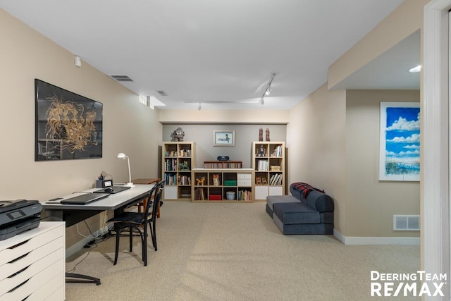 office area featuring carpet flooring, rail lighting, visible vents, and baseboards