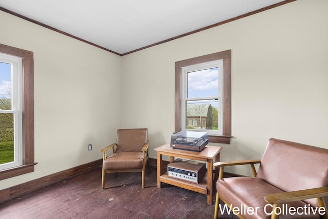 sitting room with ornamental molding, dark wood-style floors, and a wealth of natural light
