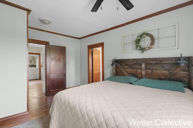 bedroom featuring a ceiling fan, ornamental molding, and wood finished floors