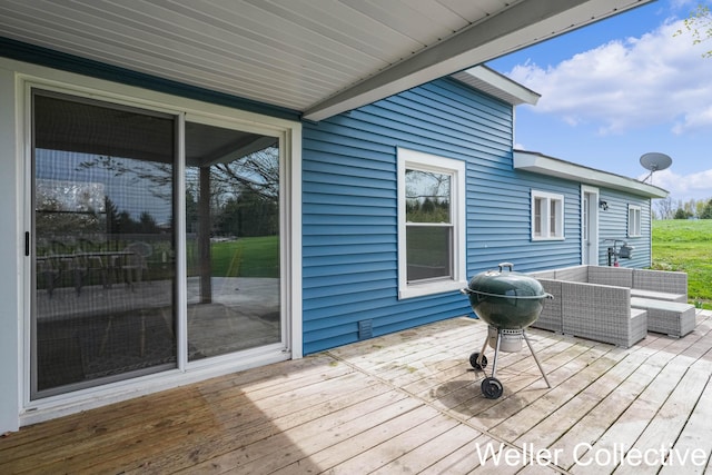 wooden terrace featuring area for grilling and outdoor lounge area