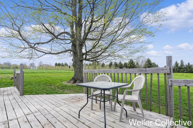 deck with a yard and a rural view