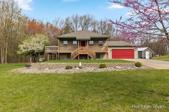 view of front of home featuring stairs, an attached garage, driveway, and a front lawn
