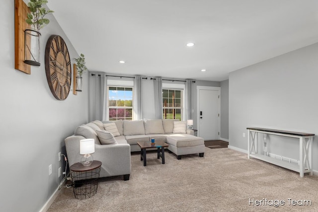 carpeted living area featuring baseboards and recessed lighting