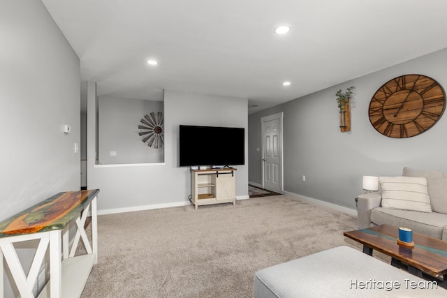 carpeted living area featuring recessed lighting and baseboards
