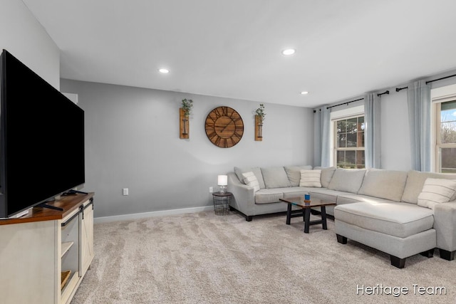 living area with recessed lighting, baseboards, and light carpet