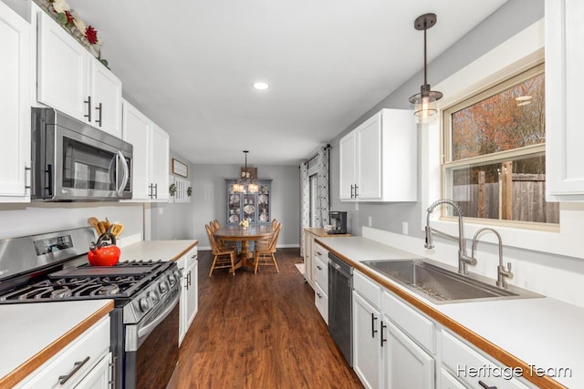 kitchen featuring a sink, white cabinetry, and stainless steel appliances