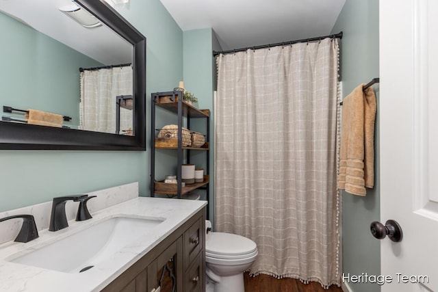 full bathroom with toilet, wood finished floors, and vanity