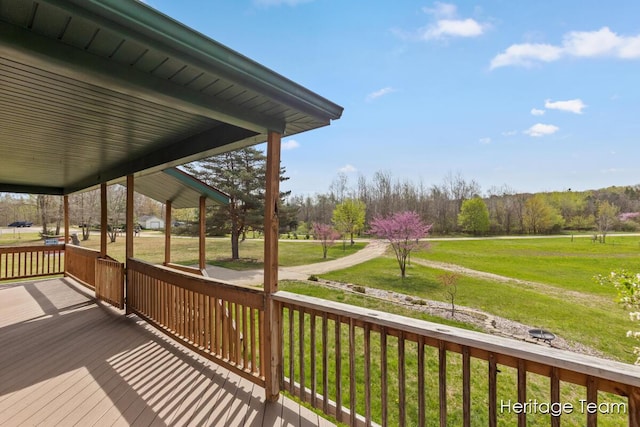wooden deck featuring a yard and a porch