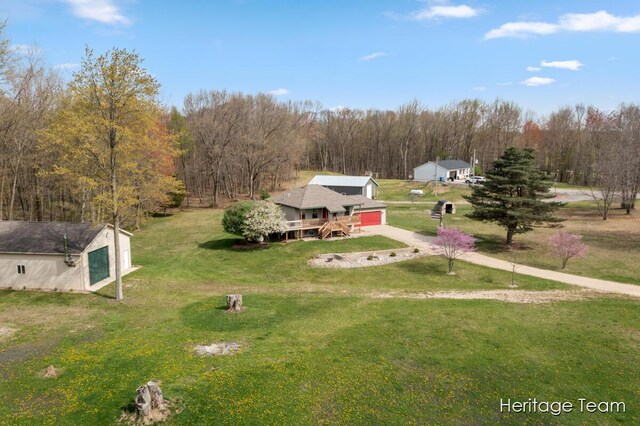 drone / aerial view featuring a wooded view