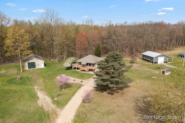 birds eye view of property with a forest view